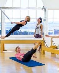 We often get asked if we do reformer classes.
Yes we have two reformers, but no we don’t run reformer classes exclusively.
As a Comprehensive Pilates Instructor, I teach the entire Pilates system - not just reformer classes - because Joseph Pilates designed his method as an interconnected, full-body approach using a variety of apparatus, each serving a unique purpose within the system.
The full Pilates system includes the Reformer, Cadillac, Wunda Chair, Ladder Barrel, Spine Corrector, Mat, and several smaller pieces of equipment. Each apparatus is designed to complement the others, helping the body find balance, strength, and control through a progressive and intelligently structured method. By working with the full range of equipment, I can tailor sessions precisely to each individual’s needs - whether that means supporting, challenging, or refining their movement in a way that a one-size-fits-all reformer class simply cannot.
While reformer classes can offer a great workout, they tend to be more generalised. Everyone in the room performs the same sequences, often at a similar pace, using the same springs and setup. The focus is typically on fitness rather than the therapeutic and corrective power of Pilates as a complete system.
In contrast, teaching the full system allows for a far more holistic and personalised experience. I can choose the right apparatus for each client’s body and goals on any given day - using the Cadillac to build stability, the Chair to develop power and balance, or the Barrels to restore alignment and flexibility. This way, the work meets the body where it is, rather than forcing the body to fit the work.
Ultimately, teaching the full Pilates system honours the original intention of Joseph Pilates - a complete method of movement that integrates mind, body, and spirit, and restores natural strength and vitality through precision and progression. It’s not just a class - it’s a whole-body education in movement.